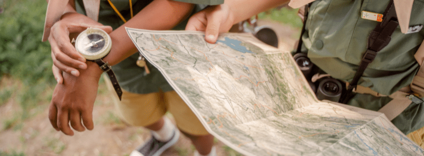 Child learning navigation during a family hike in Colorado.