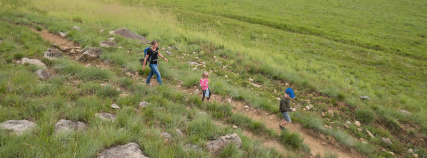 Family hiking on a Colorado trail during back-to-school season.