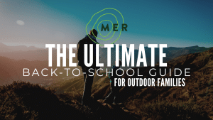 Dad and son hiking on a Colorado mountain trail during back-to-school season for outdoor families.